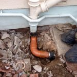 repair being made to leaking drainage pipe