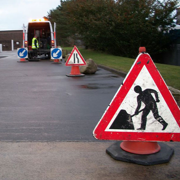 man at work roadwork sign for emergency drainage works